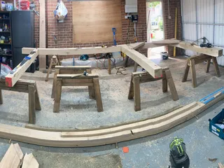 Curved oak beams cut and laid out in the workshop