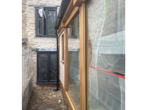 Corner of the finished orangery with the window set into the oak frame