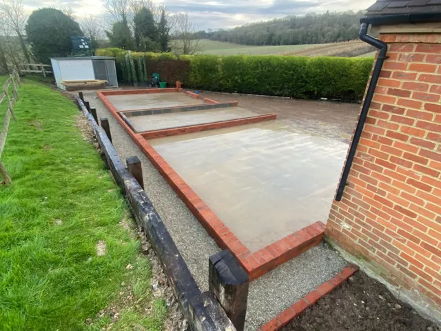 Concrete foundations and brick plinth laid for the garage before the frame