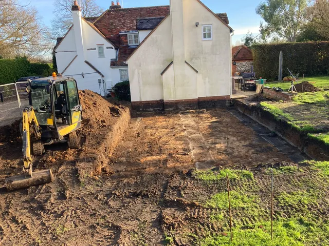 Mini digger excavating the footprint for an oak framed extension