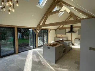 Kitchen interior with exposed oak trusses, roof lights and pendant lights