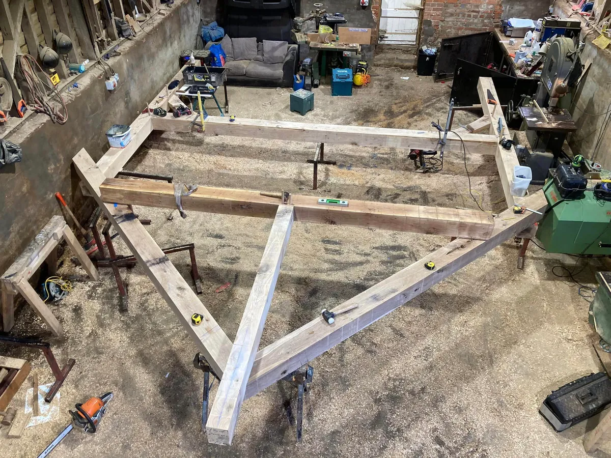 Oak frame laid out and jointed on the workshop floor before it goes to site