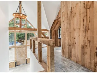 Oak gallery landing inside the finished entrance hall with oak boarded walls