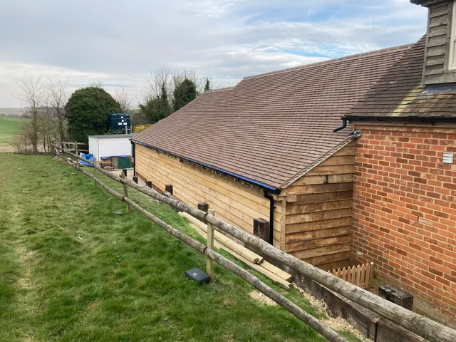 Rear elevation of the oak framed garage showing the tiled roof and oak-clad gable