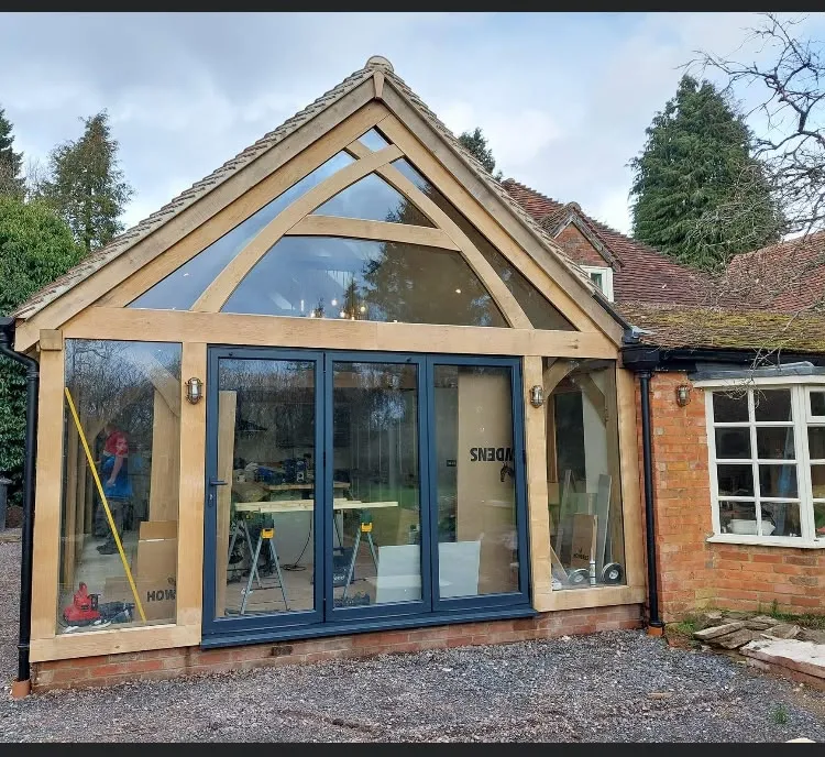 Oak framed kitchen extension with a glazed gable and bi-fold doors