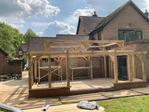 Oak frame posts standing on the new brick plinth at the rear of the house