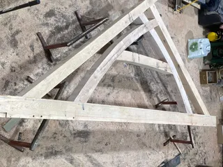 Oak roof truss laid out in the workshop before raising